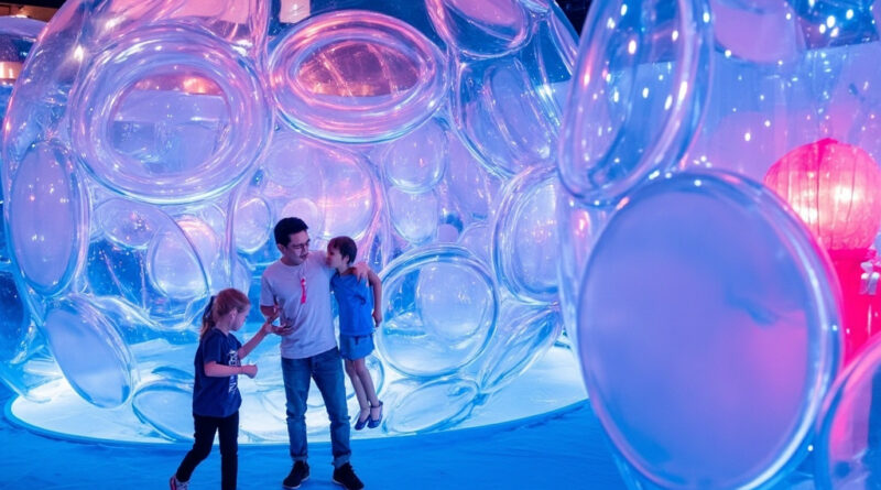 Children playing inside a colourful bubble-themed immersive room with giant inflatable structures and blue lighting at Bubble Planet Hong Kong